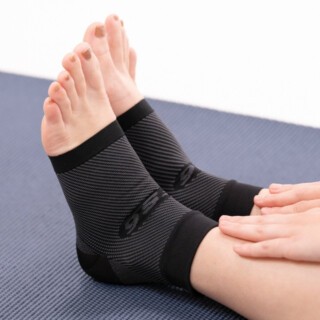 Et par fødder iført kompressionssokker til plantar fasciitis